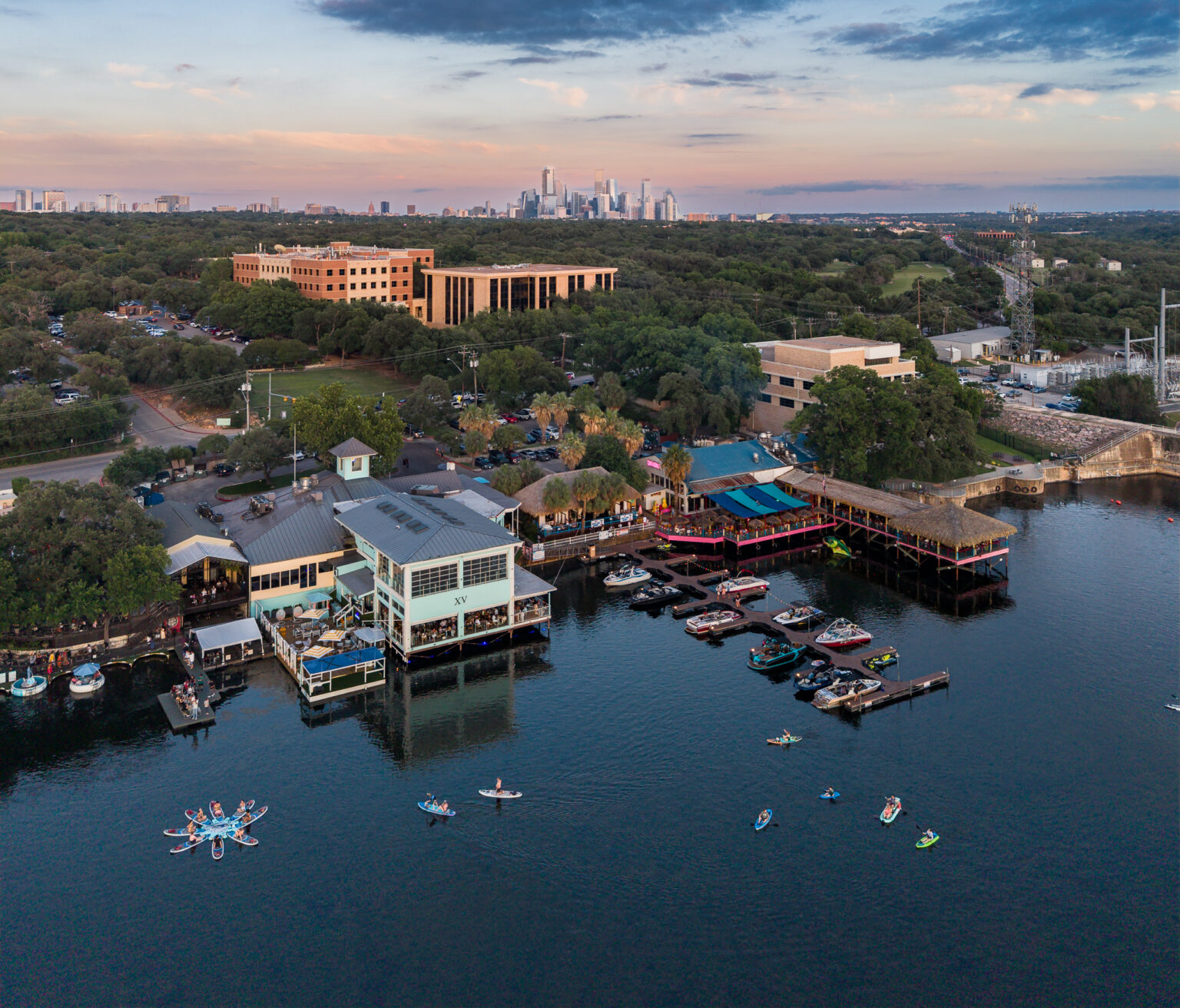 Aerial of Lake Austin waterfront restaurants with the downtown skyline — drone photography