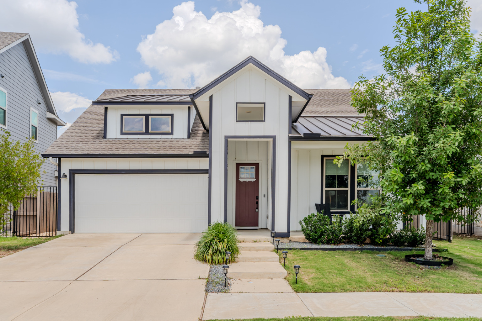 Modern farmhouse-style home exterior with red front door — Austin real estate photography