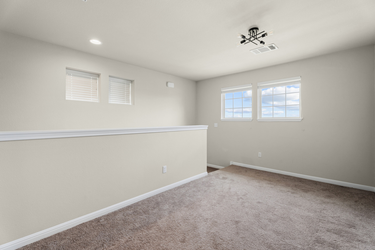 Empty carpeted bonus room — Bastrop real estate photography